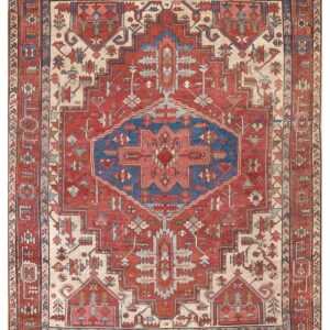 Red, cream, and blue rug featuring a bold, stepped central geometric medallion design.