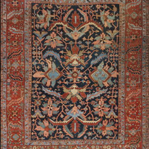 Rug with a dark blue field and intricate botanical patterns surrounded by a wide rust-colored border.
