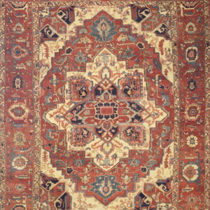 Intricate geometric and floral patterned rug featuring deep red, cream, navy, and light blue accents.