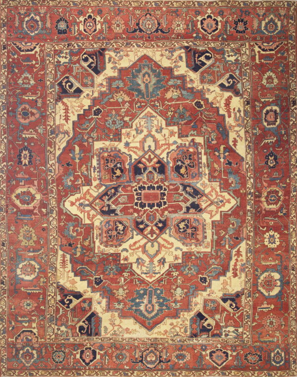 Intricate geometric and floral patterned rug featuring deep red, cream, navy, and light blue accents.