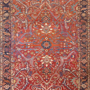 Intricate traditional rug featuring a red field, navy border, and detailed blue and tan patterns.