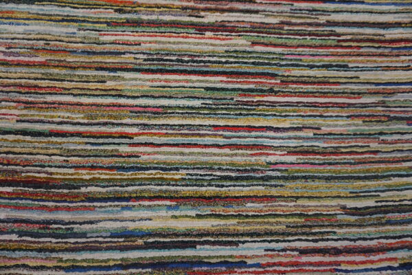 Highly textured rug with chunky, irregular horizontal stripes in numerous bright and dark colors.