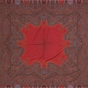 Square red textile with a wide, complex border featuring intricate paisley motifs in browns and blues.