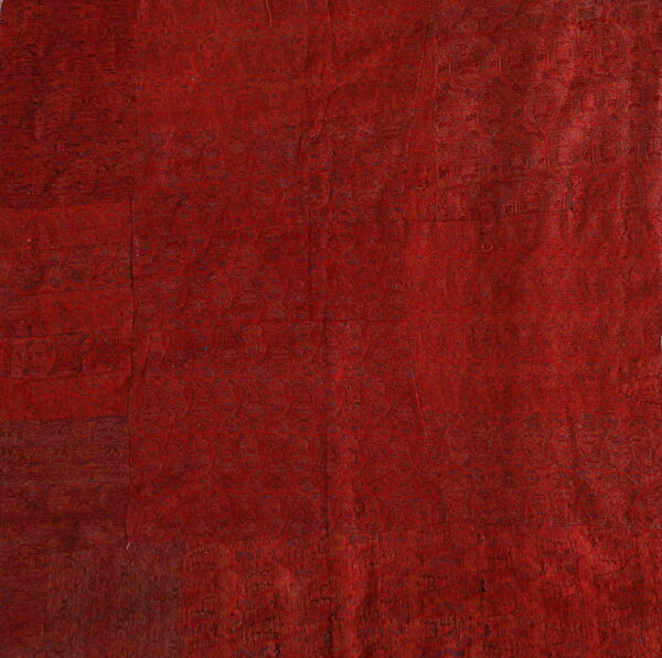 Rich red textile with intricate patterns