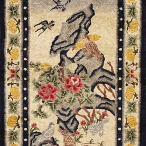 Textured rug depicting birds and pink florals against grey rocks, bordered by yellow motifs and solid dark blue.