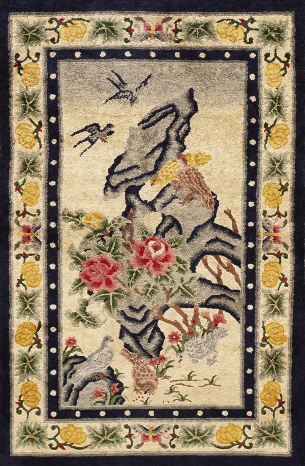 Textured rug depicting birds and pink florals against grey rocks, bordered by yellow motifs and solid dark blue.