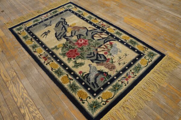 High-pile rug with a blue border, cream field, red flowers, and birds, lying on distressed wood floors.