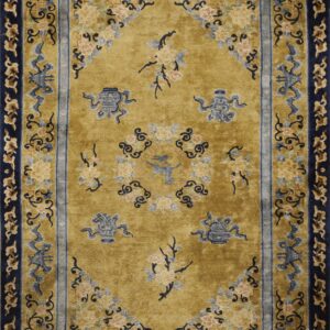 Rectangular rug with a golden field, navy blue borders, and intricate blue and peach floral designs.