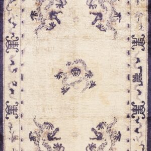 Rectangular ivory rug with deep purple traditional dragon motifs and complex patterned borders.