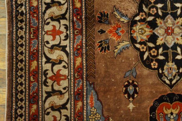 Brown, beige, and black high-pile rug featuring a dense floral medallion and detailed multi-stripe borders.