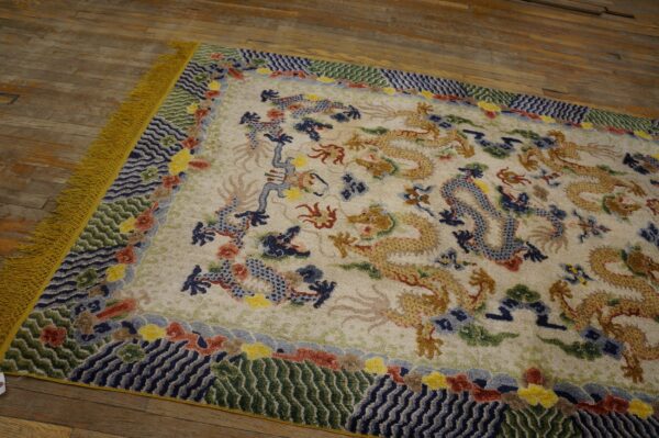 Cream rug featuring golden and blue dragons, a colorful patterned border, and yellow fringe on rustic wood planks.