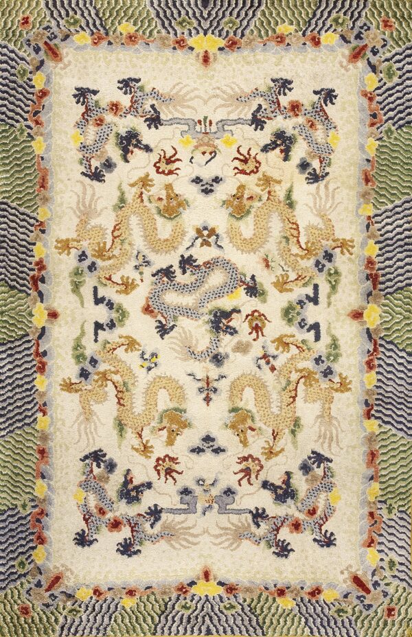 Off-white rug features golden dragon designs and borders of green and navy zigzag patterns.
