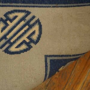 Navy rug with intricate pattern detail.