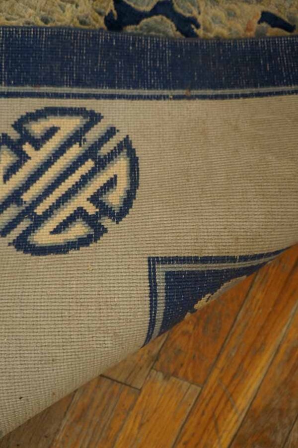 Navy rug with intricate pattern detail.