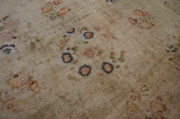 Vintage light cream color european influenced florals luxurious silk pile chinese room size rug 4 Beige high-sheen rug featuring scattered, embossed floral designs in muted blue, pink, and peach colors.