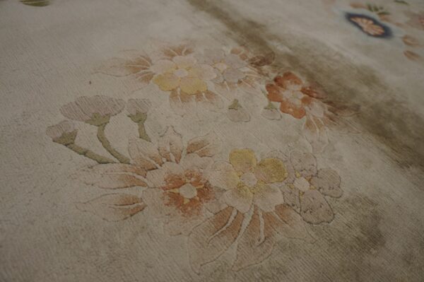 Vintage light cream color european influenced florals luxurious silk pile chinese room size rug 7 Beige area rug with carved floral designs in soft pink, pale yellow, terracotta, and olive green.