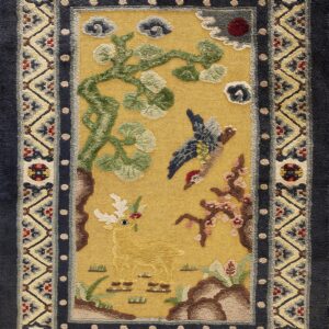 Yellow field rug with a detailed deer and bird scene, surrounded by geometric navy and tan borders.