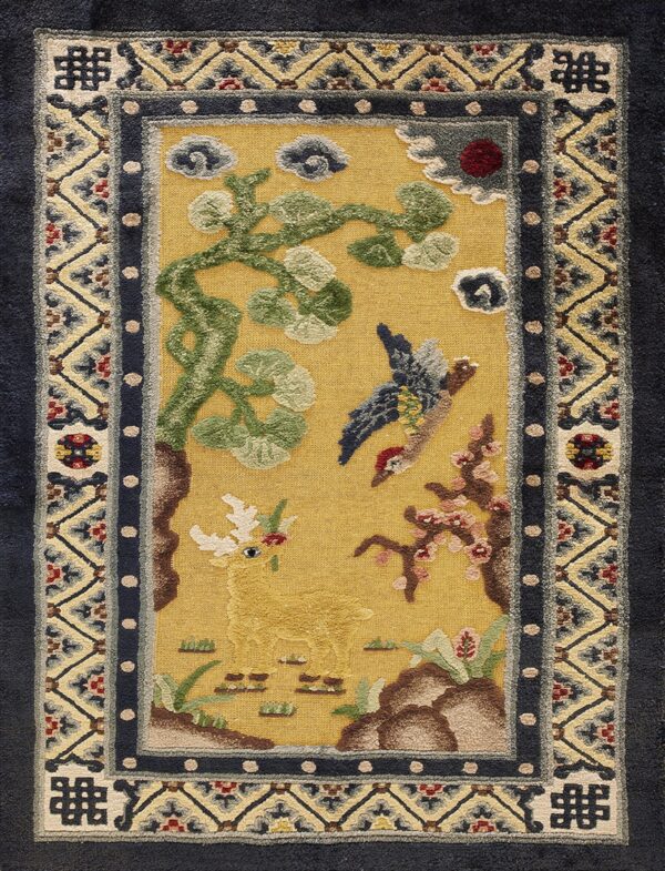 Yellow field rug with a detailed deer and bird scene, surrounded by geometric navy and tan borders.