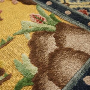 High-low pile rug detail showing a bright gold flat field contrasting with raised brown, green, and blue patterns.