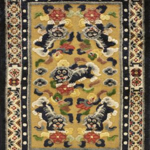 Thick-textured gold rug displaying a traditional pattern of five stylized lions within geometric borders.