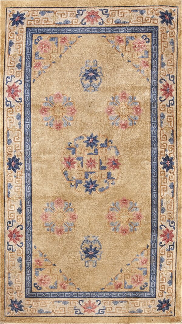 Traditional tan rug with blue and pink floral medallions surrounded by detailed scrolling borders.