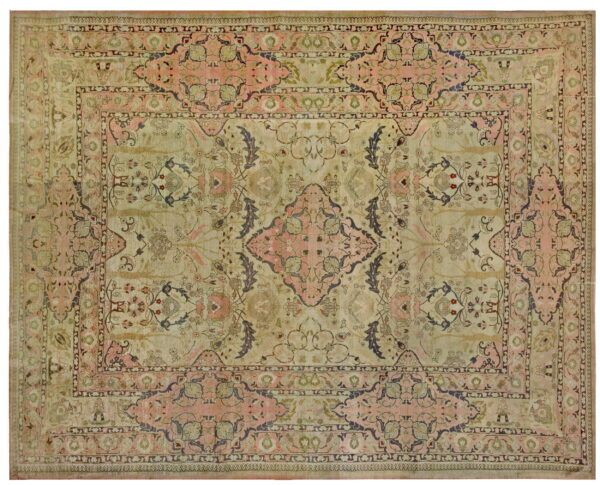 A distressed rug featuring a central medallion and botanical motifs in muted pink, beige, and dark taupe.