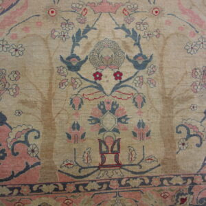 Beige rug featuring a detailed floral and bird pattern in dusty rose, slate blue, and dark red.