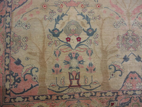Beige rug featuring a detailed floral and bird pattern in dusty rose, slate blue, and dark red.