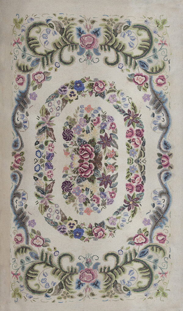 Off-white rug featuring a dense, muted floral medallion of pink, blue, and purple blossoms.