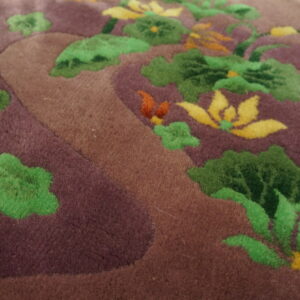Plush rug detail showing deep purple and brown fields with green leaves and yellow water lily designs.