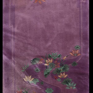 Plush mauve rug with sculpted floral designs in contrasting shades of green, rust, and yellow.