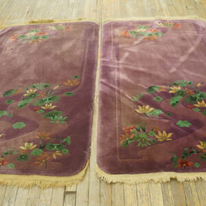 Matching high-pile dusty purple runners with carved yellow and orange floral patterns on light wooden planks.