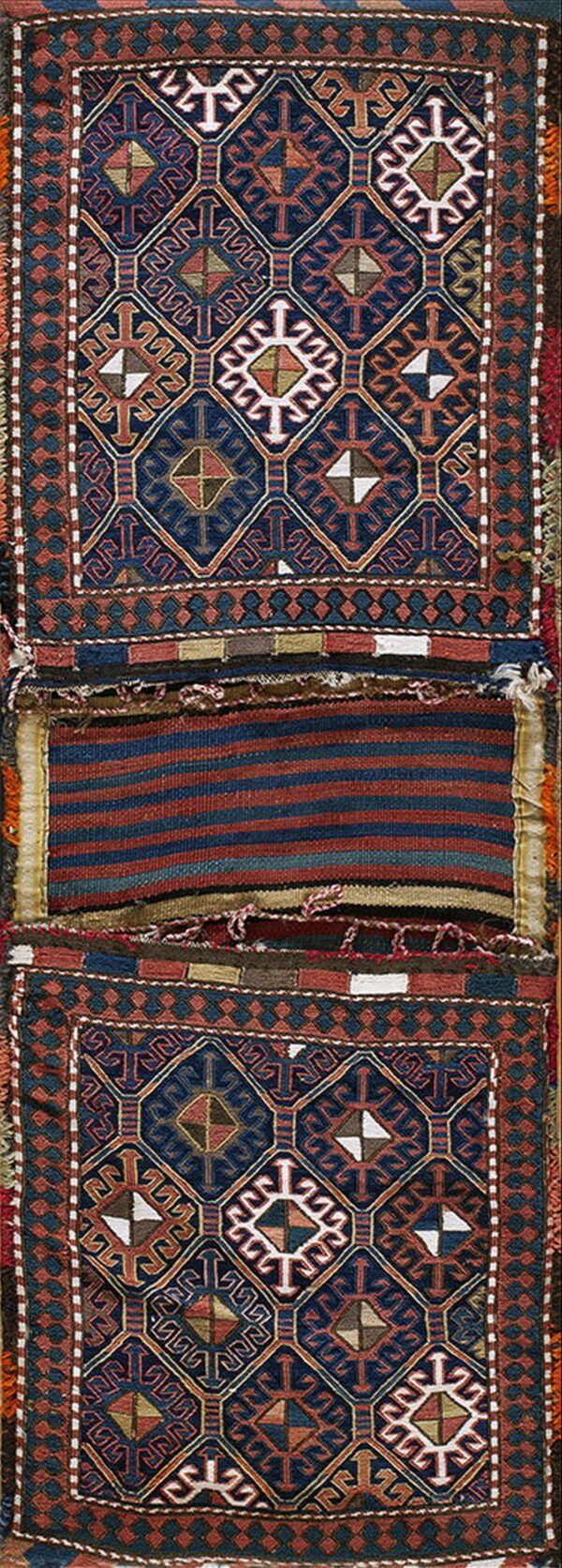 Complex geometric textile featuring navy and terracotta pile sections joined by a center striped flatwoven band.