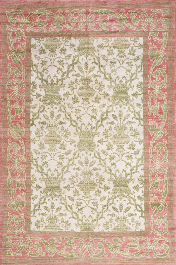 A low-pile rug displaying repeating green urns on cream, framed by an elaborate rose and green border.