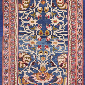Ornate blue runner rug featuring a complex central traditional pattern in cream, red, gold, and olive green.