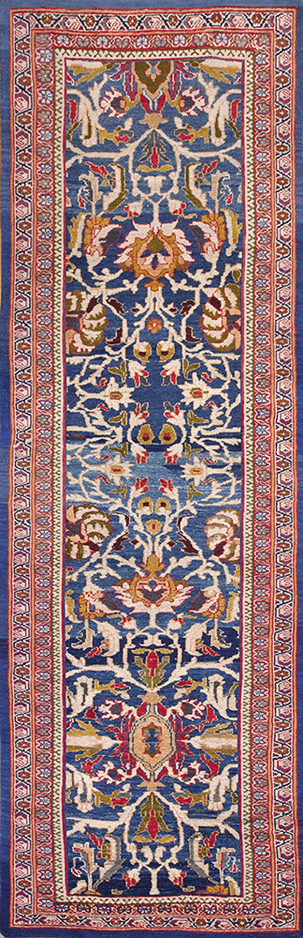 Ornate blue runner rug featuring a complex central traditional pattern in cream, red, gold, and olive green.