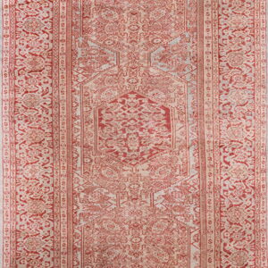 Red and beige runner rug featuring a faded traditional medallion design and multiple intricate borders.