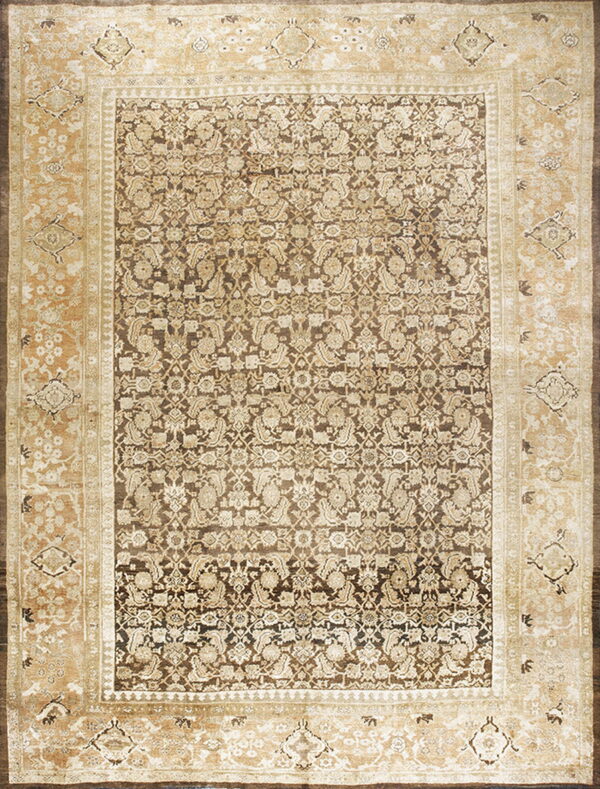 Traditional area rug featuring a dense dark brown floral pattern surrounded by a wide, patterned light beige border.