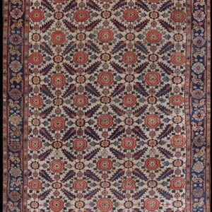 Cream, navy, and rust-colored runner rug with dense floral geometric designs and a wide dark border.