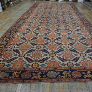 Long rug featuring coral, navy, and cream stylized floral patterns on rustic wood floor.