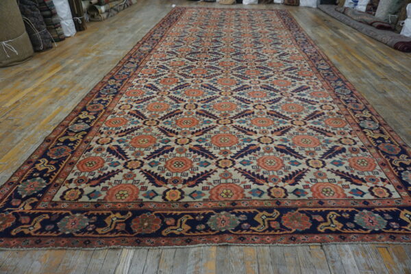 Long rug featuring coral, navy, and cream stylized floral patterns on rustic wood floor.