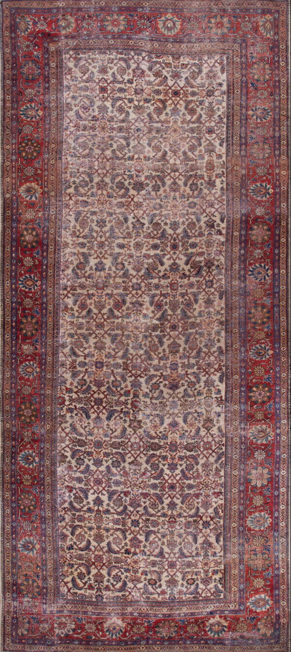 Distressed runner rug with a cream field, all-over faded red and blue floral motifs, and a wide red border.