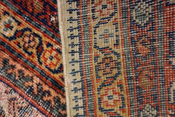 Two rugs side by side show contrasting textures and geometric patterns in red, navy, beige, and teal.