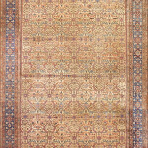 Low-pile rug with complex repeating geometric designs on a light tan field and a prominent dark blue border.