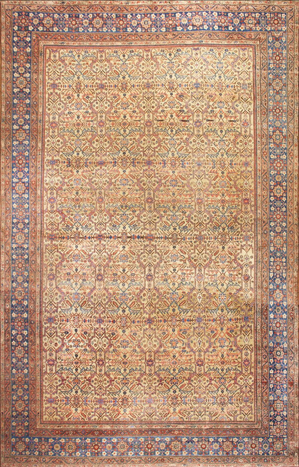 Low-pile rug with complex repeating geometric designs on a light tan field and a prominent dark blue border.