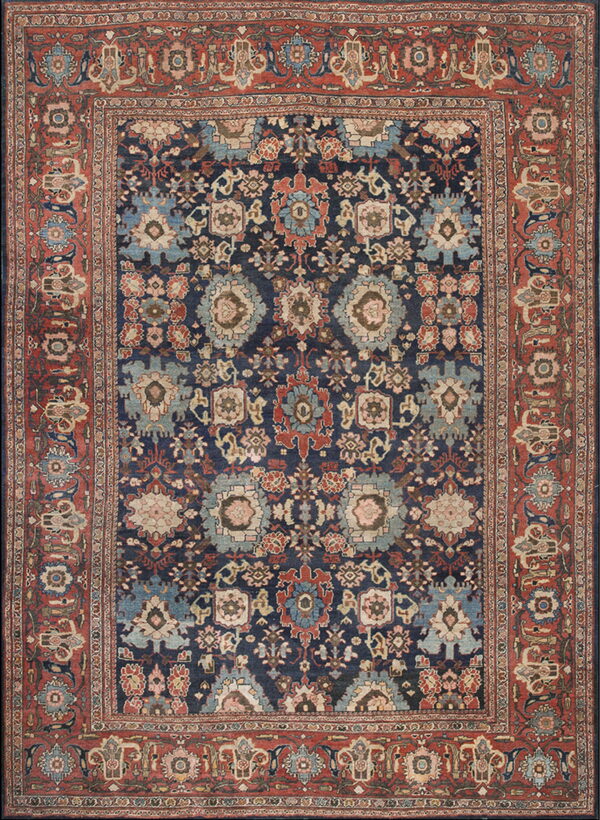 Traditional navy blue and light blue medallion pattern rug with a wide rust red ornamental border.