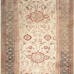 Low-pile rug with a cream field, faded red central motifs, and ornate slate-gray patterned borders.