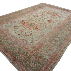 Low pile traditional rug with light gray field, red floral designs, and green patterned borders.