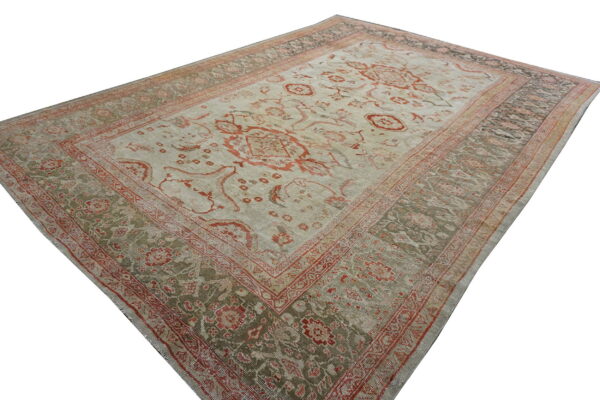 Low pile traditional rug with light gray field, red floral designs, and green patterned borders.