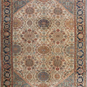 Intricate floral rug with an off-white field, featuring blue, rust, and terracotta motifs and dark navy borders.